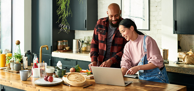 Couple making dinner together in kitchen with fresh produce